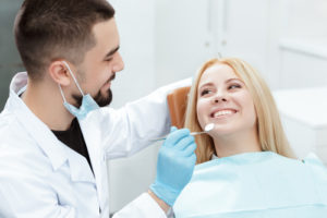 Should You Get a T-Scan Bite Test? Patient smiling in dental chair