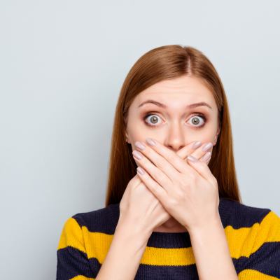Woman covering her mouth
