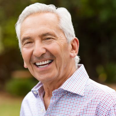 Older man with dentures smiling