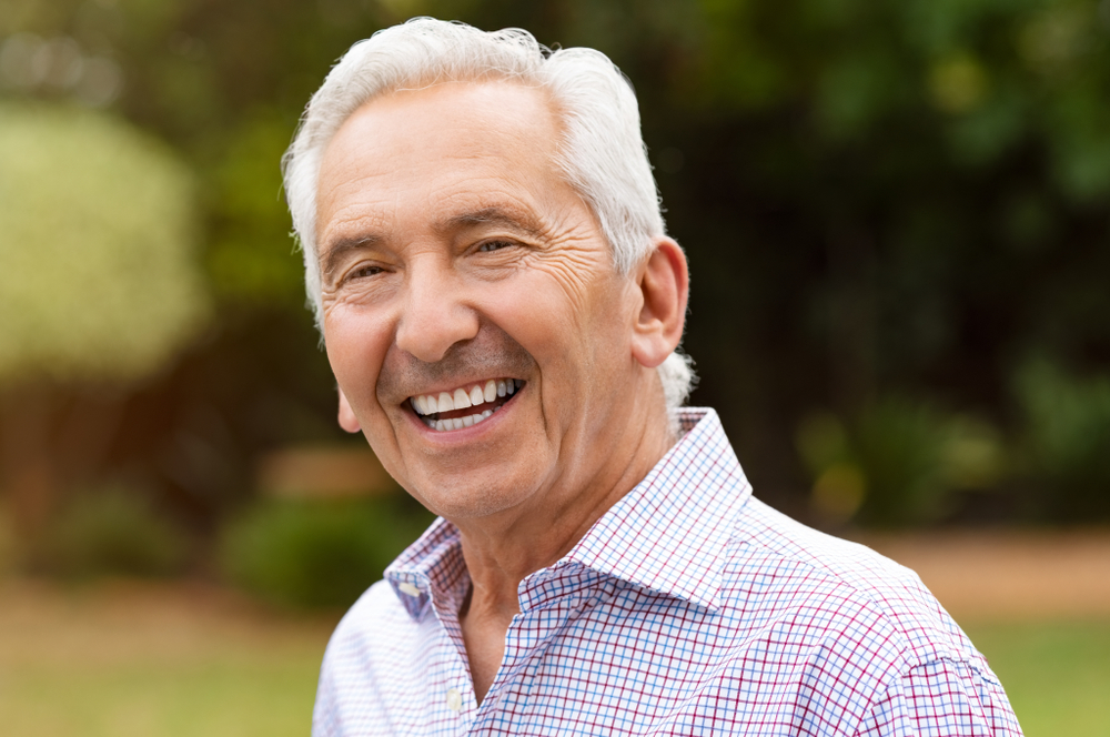 Older man with dentures smiling