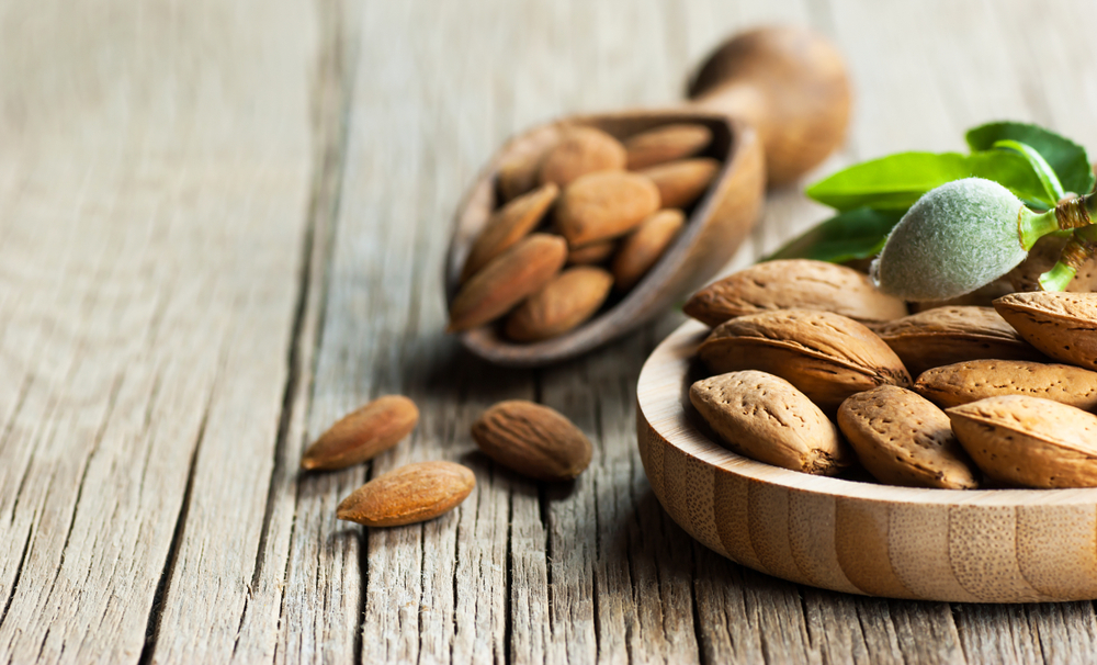 Bowl of almonds on wooden table