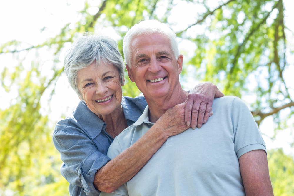 Older couple smiling in the park