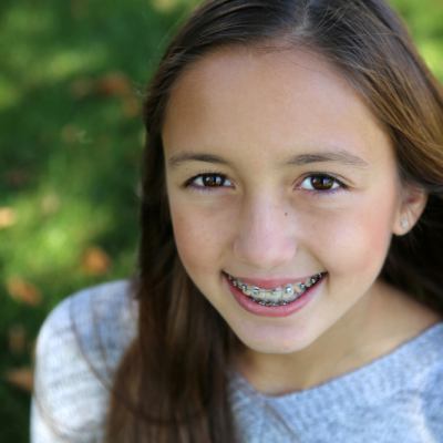 Young girl with braces smiling