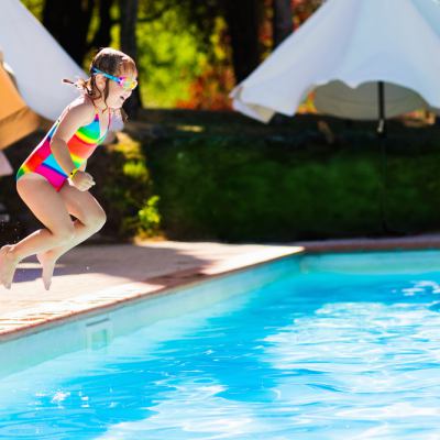 Child jumping into pool