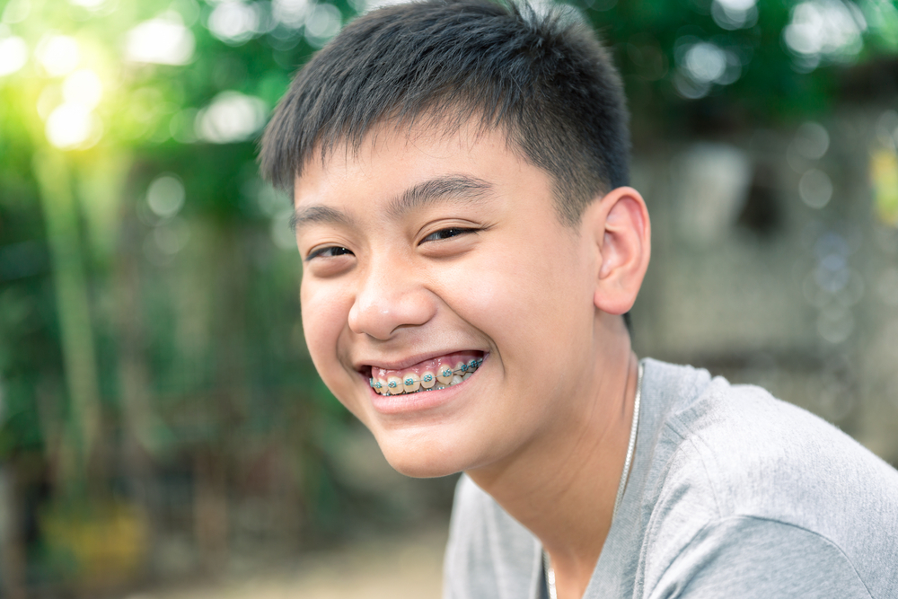 Young boy with braces smiling