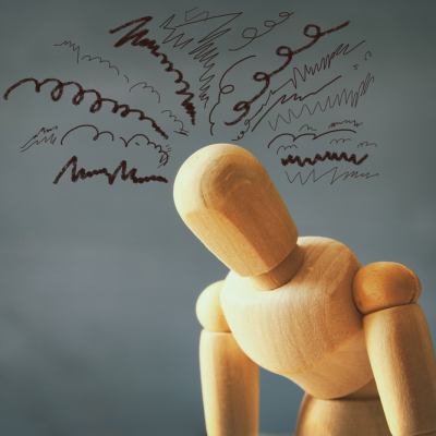 Wooden doll looking frustrated