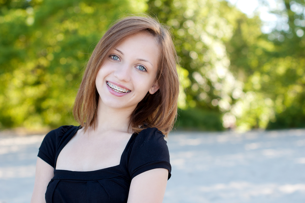 Young girl with braces smiling